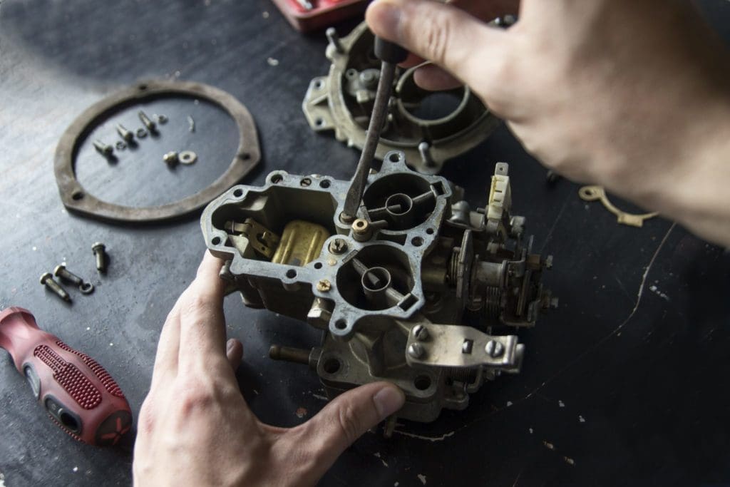 man repairing metal casting mold