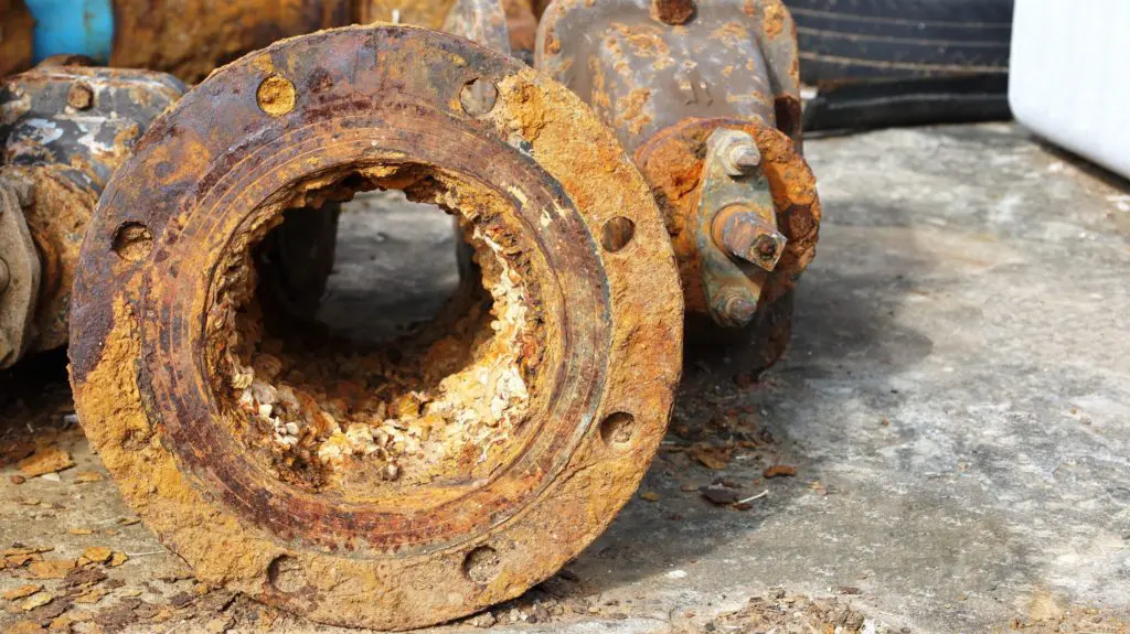 internal pipeline corrosion causes rusty metal panel, corrosion damage along a seam