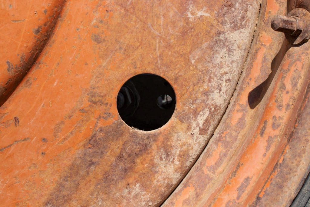 A worn and rusty tractor part