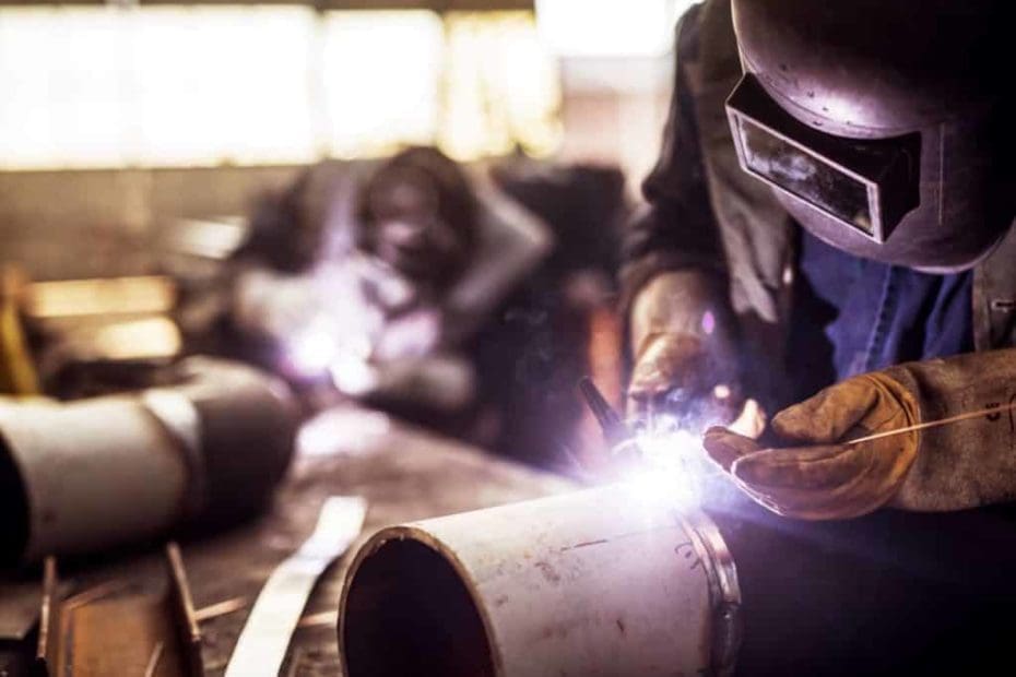 closeup of welder working on a portion of prefabricated pipe spools